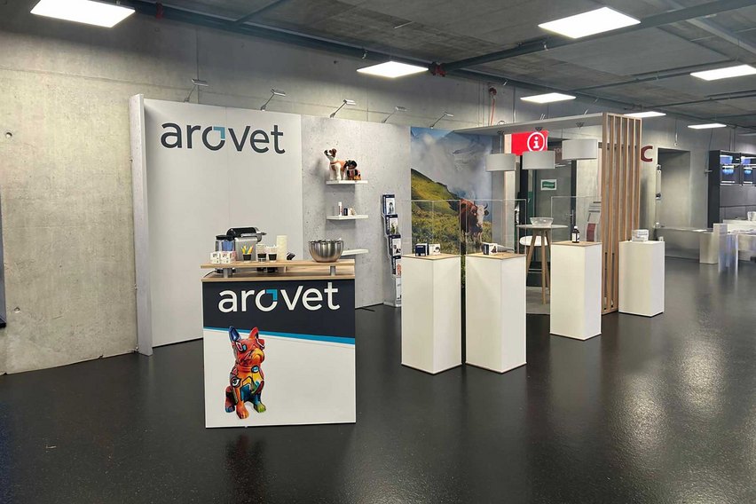 Ein Messestand mit einem Logo und Tierfiguren.