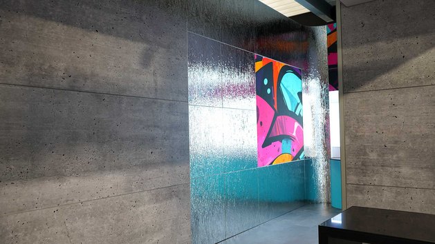 Ein Raum mit Wänden aus grauem Beton und einem bunten Graffiti.